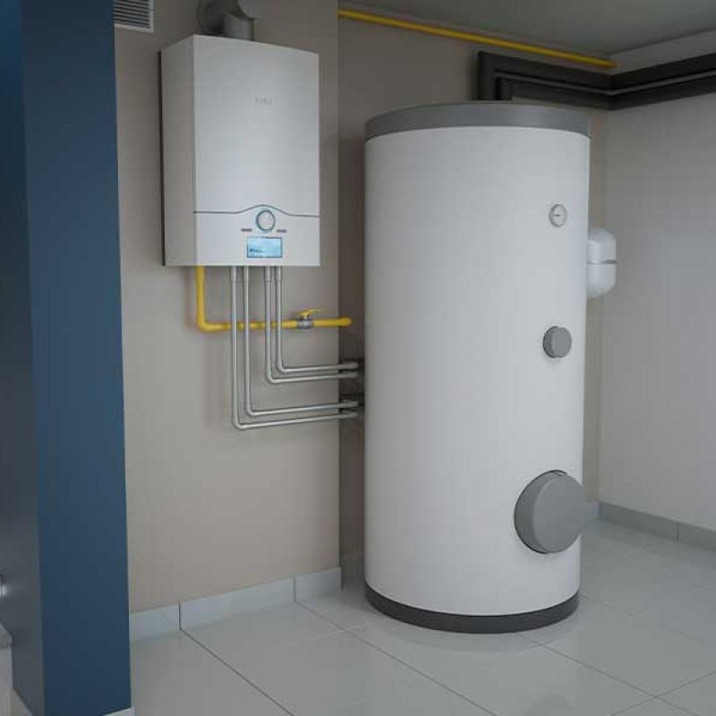 Modern basement with a water heater and boiler system installed, next to stairs for efficient home heating.