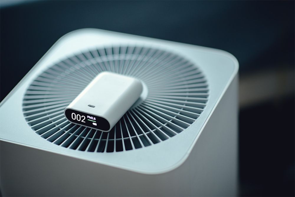 Modern air purifier with digital PM2.5 display screen for monitoring air quality indoors.